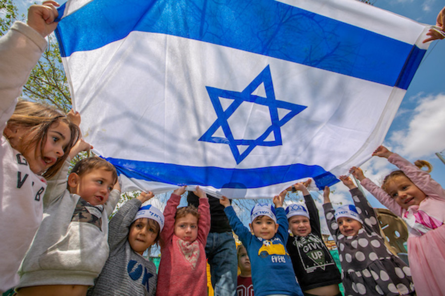 Israeli children hold Israeli flags ahead of Israel 73rd Independence Day, at a kindergarten in Moshav Yashresh, April 13, 2021. (Photo: Yossi Aloni/Flash90)
