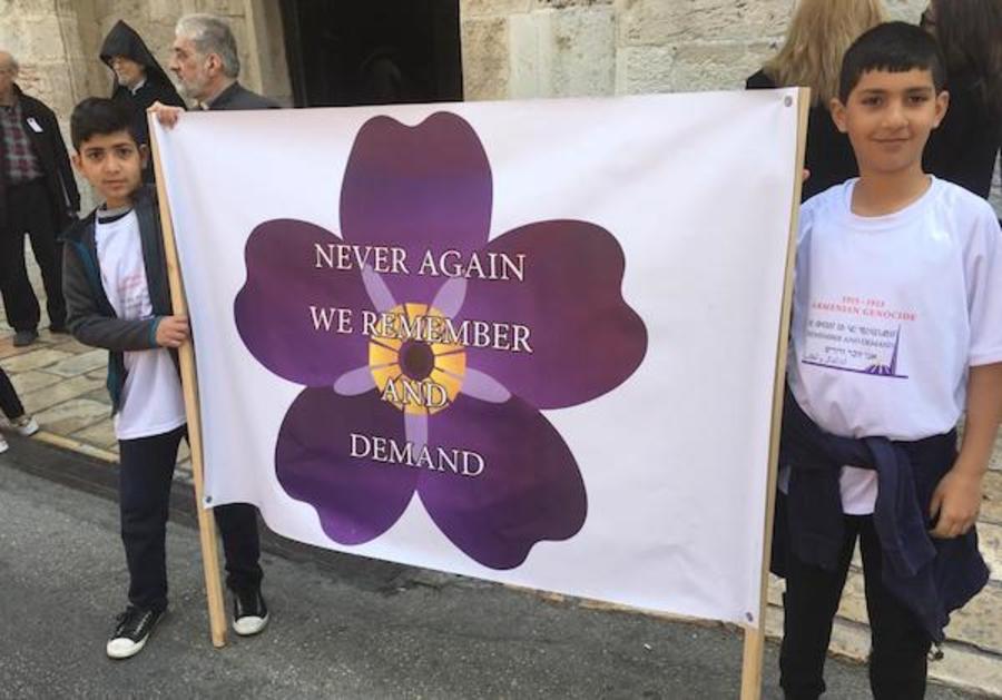Children hold up a sign during an observance of Armenian Genocide Memorial Day in the Old City of Jerusalem. (Photo: All Israel News)