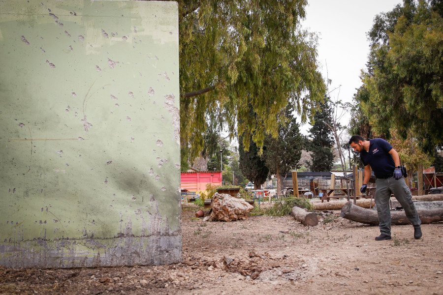 An Israeli police sapper inspects the scene where a rocket fired from the Gaza Strip fell near houses at a kibbutz in southern Israel on April 24, 2021. (Photo: Flash90)
