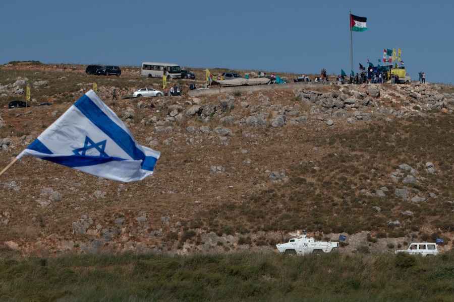 Protesters waving the Lebanese flag on the Lebanese border with Israel, as seen from the Israeli side. May 20, 2021. (Photo: Basel Awidat/Flash90)