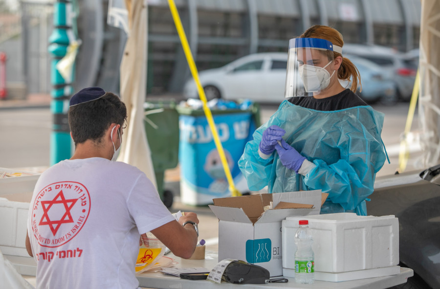 Healthcare workers take test samples of Israelis in a drive-thru complex to check if they have been infected with the coronavirus, April 18, 2021. (Photo: Yossi Aloni/Flash90)