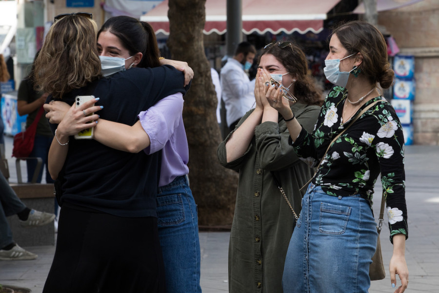 Women hug on Jaffa Street in downtown Jerusalem on October 25, 2020. (Photo: Nati Shohat/Flash90)