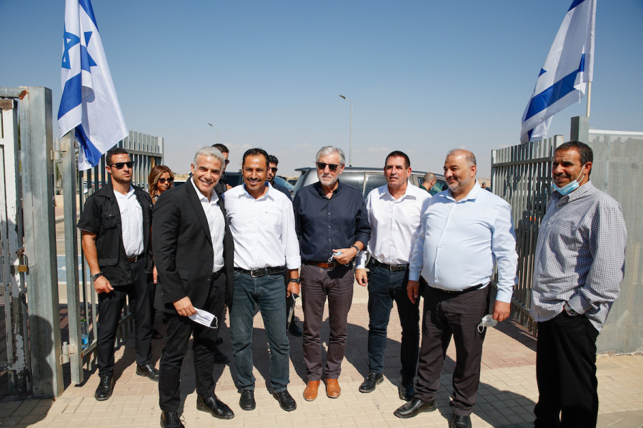 Foreign Minister Yair Lapid and Mansour Abbas, head of the Ra'am party, visit at a high school in the Neve Midbar Regional Council, a region of southern Israel populated by Negev Bedouins, Oct. 21, 2021. (Photo: Flash90)