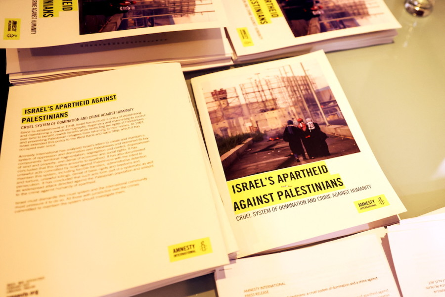 Copies of Amnesty International's report named "Israel's Apartheid Against Palestinians: Cruel System of Domination and Crime Against Humanity" are seen at a press conference at the St. George Hotel, in East Jerusalem, February 1, 2022. (Photo: Reuters/Ronen Zvulun)