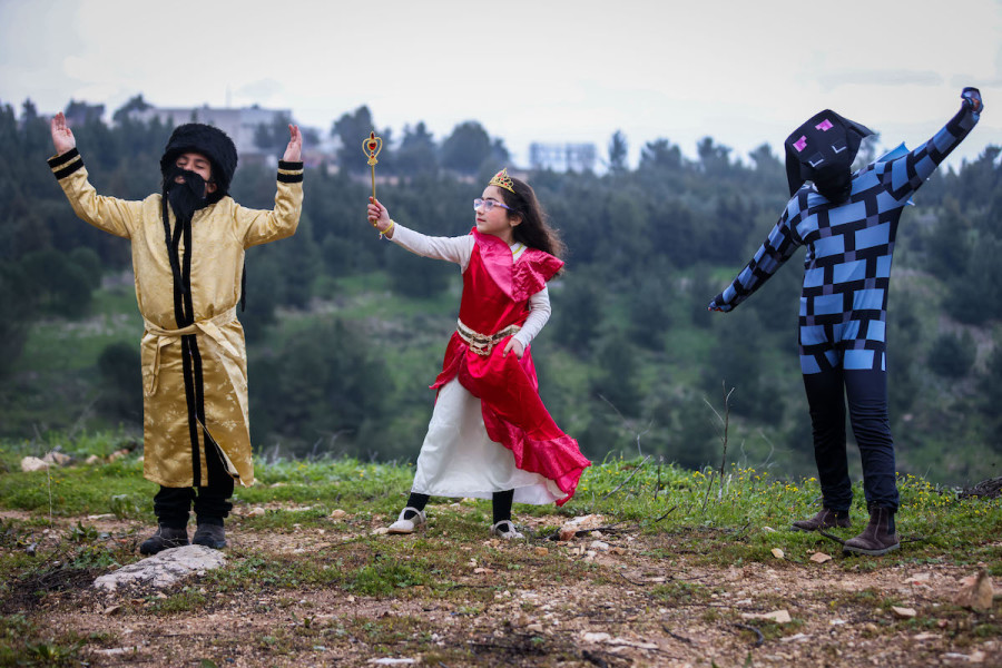 Children dressed in costumes pose for a picture in the northern Israeli city of Tzfat, Mar. 13, 2022, ahead of the Jewish holiday of Purim. (Photo: David Cohen/Flash90_
