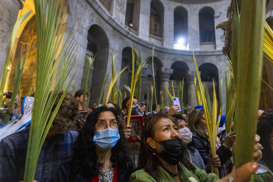 Christian worshippers hold palm branches as they walk in a procession on Palm Sunday, in the Church of the Holy Sepulchre, in Jerusalem's Old City, April 10, 2022. (Photo: Olivier Fitoussi/Flash90