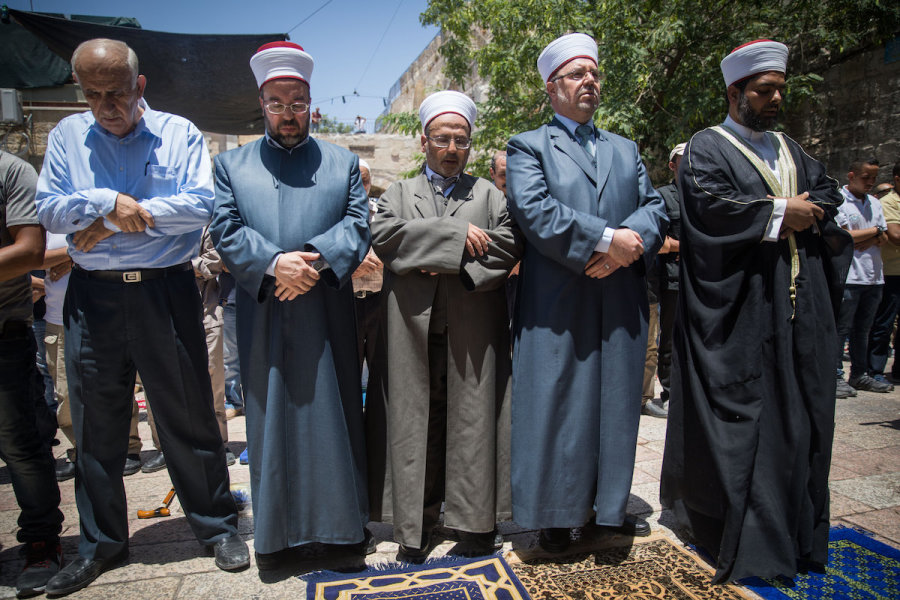 Illustrative - Waqf officials lead Muslim prayers outside the Temple Mount in Jerusalem's Old City, July 16, 2017. (Photo: Yonatan Sindel/Flash90