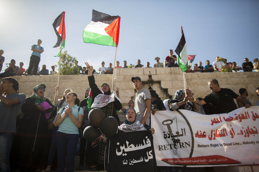 Arabs wave the Palestinian national flag and hold banners as they demonstrate at the Damascus Gate in the Old City of Jerusalem, May 15, 2014, to mark Nakba Day (Photo: Yonatan Sindel/Flash90)