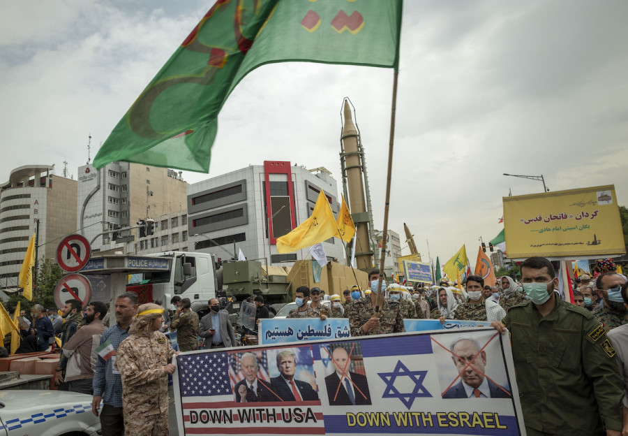 Members of the Islamic Revolutionary Guard Corps (IRGC) carrying an anti-U.S. and anti-Israel placard with portraits of Israeli and American leaders under an Iranian Kheibar Shekan Ballistic missile in downtown Tehran during a rally commemorating the International Quds Day, also known as the Jerusalem day, April 29, 2022. (Photo: Morteza Nikoubazl/NurPhoto via Reuters)