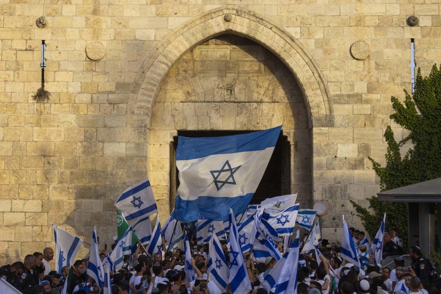 Israelis holding flags as they dance at the Damascus Gate in Jerusalem's Old City, during Jerusalem Day celebrations, May 29, 2022. (Photo: Olivier Fitoussi/Flash90)