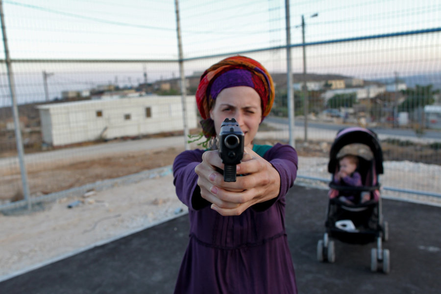 Illustrative - An Israeli woman practices firing a gun at the Jewish settlement of Pnei Kedem near Bethlehem. (Photo: Nati Shohat/Flash90)