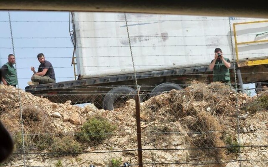 Lebanese men looking into Israel from an observation post near the border. Picture released by the military on June 8, 2022. (Photo: Israel Defense Forces)