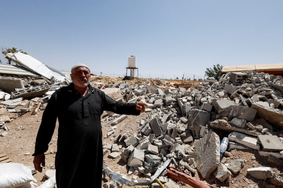 Palestinian Mahmoud Najajreh points at his demolished house in Masafer Yatta, south of Hebron, May 31, 2022. (Photo: Reuters/Mussa Qawasma)