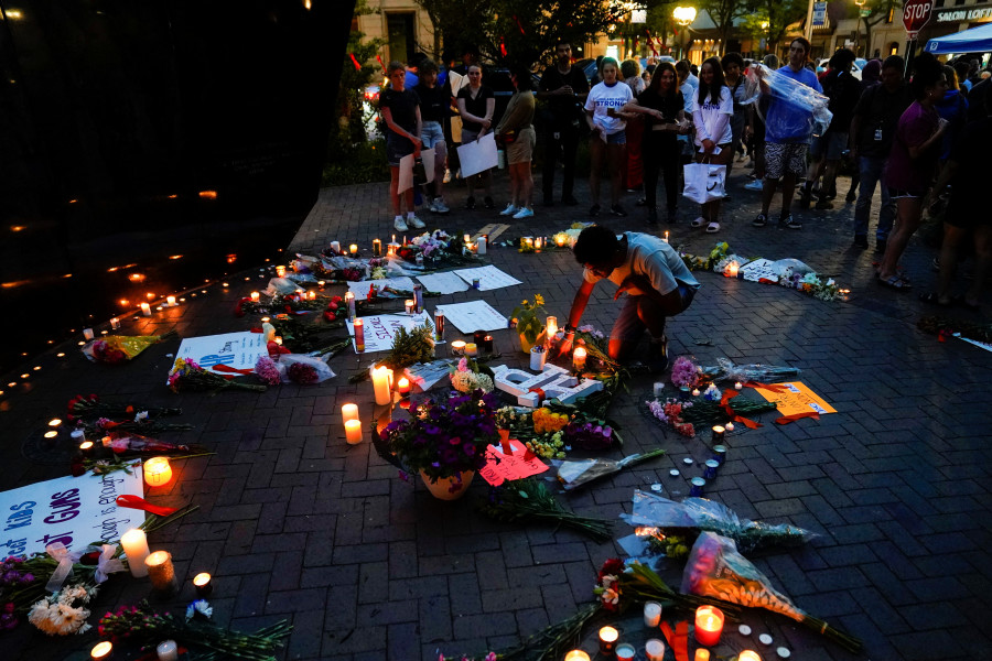 Community members gather at a memorial site near the parade route the day after a mass shooting at a July 4th parade in the Chicago suburb of Highland Park, Illinois, July 5, 2022. (Photo: Reuters/Cheney Orr)
