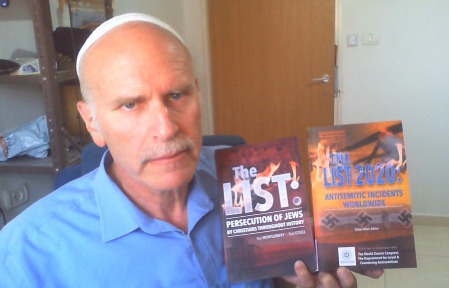 Gidon Ariel, executive director of Root Source, holding "The List 2020: Antisemitic Incidents Worldwide" and "The LIST: Persecution of Jews by Christians Throughout History" (Photo courtesy)