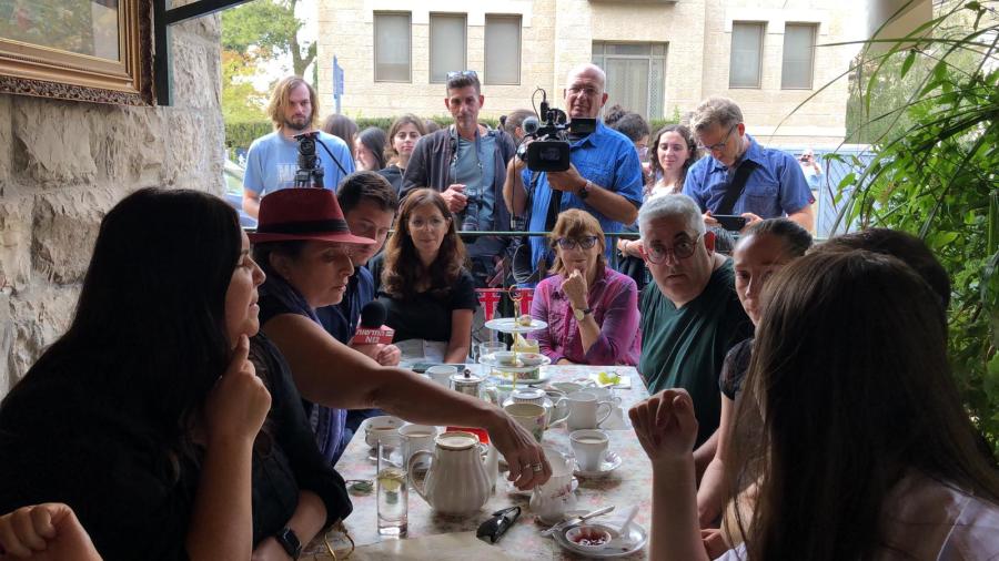British ex-pats and tourists gather at the Kumkum Tea House in Jerusalem to watch the livestream of Queen Elizabeth's funeral together. (Photo: All Israel News)