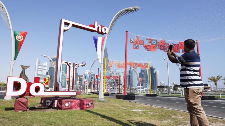 A man takes a picture of a decorated road in Doha on Nov. 12, 2022, ahead of the World Cup finals in Qatar opening Nov. 20. (Photo: Kyodo via Reuters)