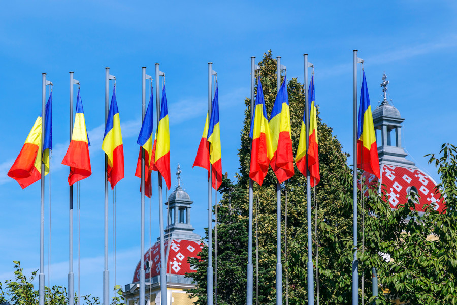 Romanian flags and roofs of the old building in the Avram Iancu Square.