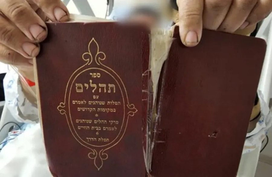 The Book of Psalms, held by the bombing victim, prevented a shard of debris from piercing his body. (Photo: Shaare Zedek Medical Center)