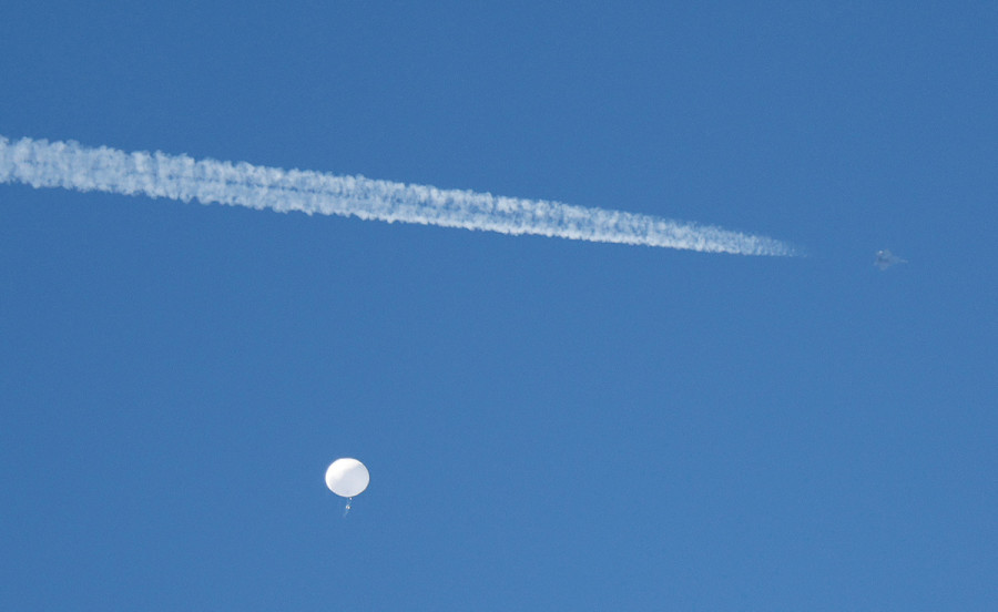 A jet flies by a suspected Chinese spy balloon as it floats off the coast of Surfside Beach, South Carolina, Feb. 4, 2023. (Photo: REUTERS/Randall Hill)