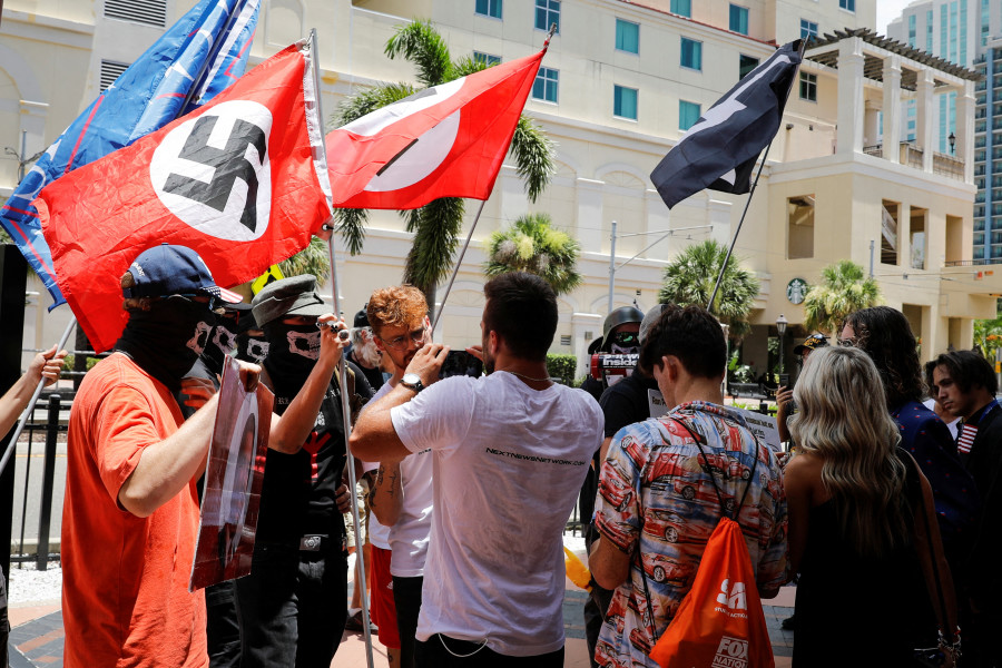 People waving Nazi swastika flags argue with conservatives during a protest outside the Tampa Convention Center, where Turning Point USA's (TPUSA) Student Action Summit (SAS) is being held, in Tampa, Florida, U.S. July 23, 2022. REUTERS/Marco Bello