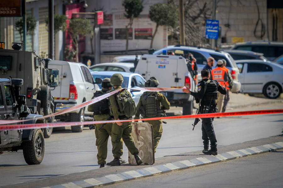 Israeli security forces secure the scene of a shooting attack where two Israelis were shot dead in Hawara, in the West Bank, near Nablus, Feb. 26, 2023. Photo by Nasser Ishtayeh/Flash90