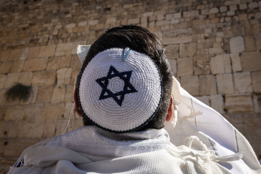 A Jewish worshipper covers himself with a prayer shawls as he prays at the Western Wall in Jerusalem's Old City, during the priestly blessing at the Jewish holiday of Sukkot, Oct. 12, 2022. (Photo: Olivier Fitoussi/Flash90)