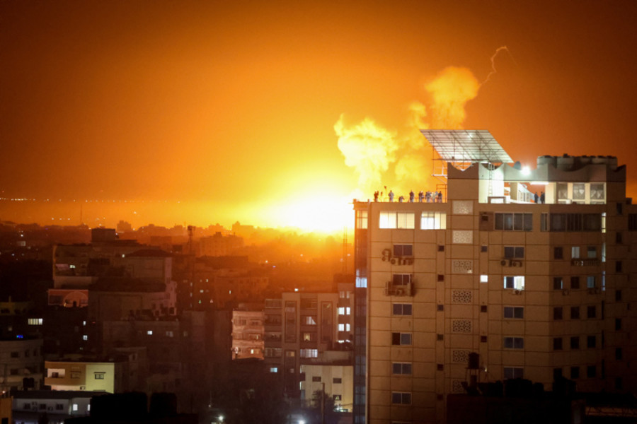 Flames rises above buildings in Gaza City as Israel launches air strikes on the Palestinian enclave late April 6, 2023. Photo by Atia Mohammed/Flash90