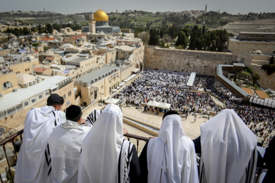 Jewish worshippers cover themselves with prayer shawls attend the Cohen Benediction priestly blessing prayer near the Western Wall, Judaism's holiest prayer site, in Jerusalem's Old City, during the Jewish holiday of Passover which commemorates the Israelites' hasty departure from Egypt, April 9, 2023. Photo by Noam Revkin Fenton/Flash90