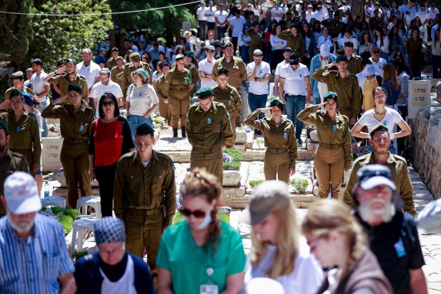 Israelis stand still in silence next to graves of Israeli soldiers at the Mt Herzl military cemetery in Jerusalem, as a two minute siren sounded across Israel, marking Memorial Day, Apr. 25, 2023. (Photo: Erik Marmor/Flash90)