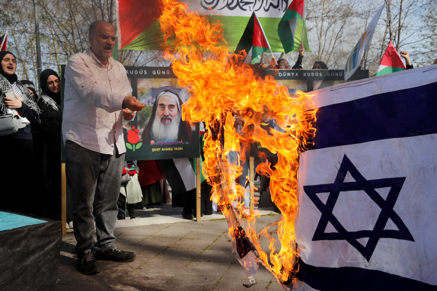 Pro-Palestinian demonstrators set fire to an Israeli flag during a rally to mark the annual Al-Quds Day (Jerusalem Day), during the holy month of Ramadan in Istanbul, Turkey, April 14, 2023. (Photo: REUTERS/Dilara Senkaya)