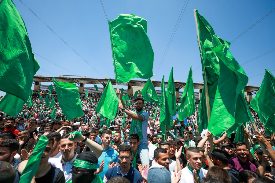 Palestinian supporters wave the Hamas movement's flag during a rally at Birzeit University, near the West Bank city of Ramallah, May 19, 2022. (Photo: Flash90)