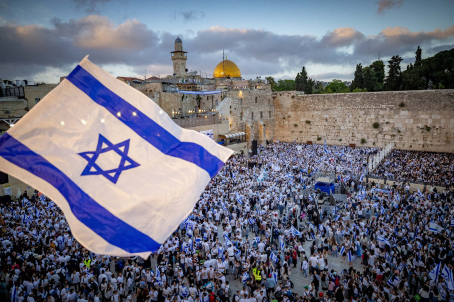 Jews hold Israeli flags as they dance at the Western Wall in Jerusalem's Old City, during Jerusalem Day celebrations, May 18, 2023. (Photo: Yonatan Sindel/Flash90)