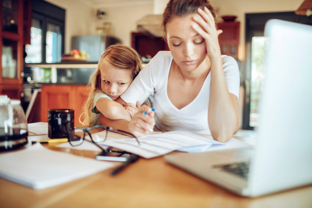 Mum stressed sitting at the computer | HealthMasters