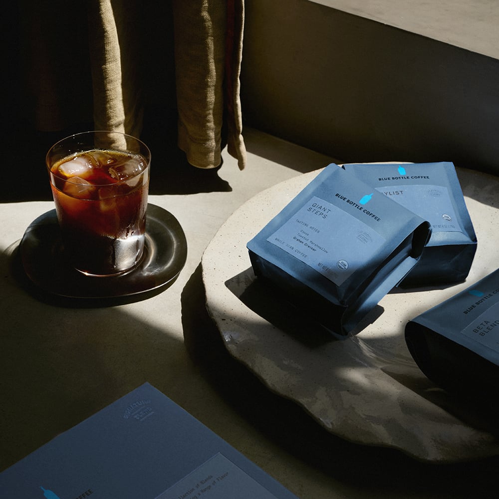 Cold Brew Set box, glass of cold brew and bags of coffee on a table.