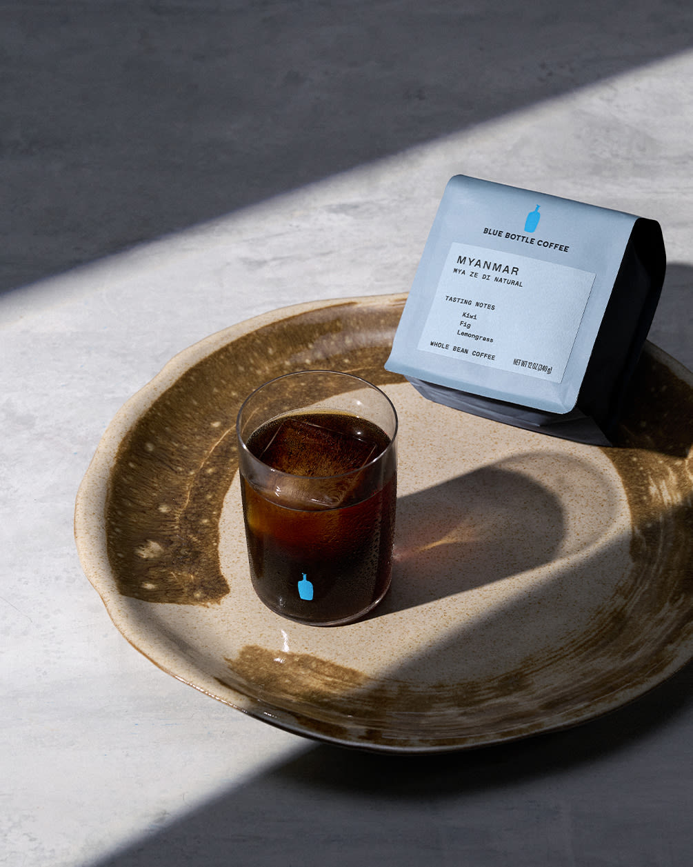 whole bean single origin coffee from myanmar and glass of iced coffee