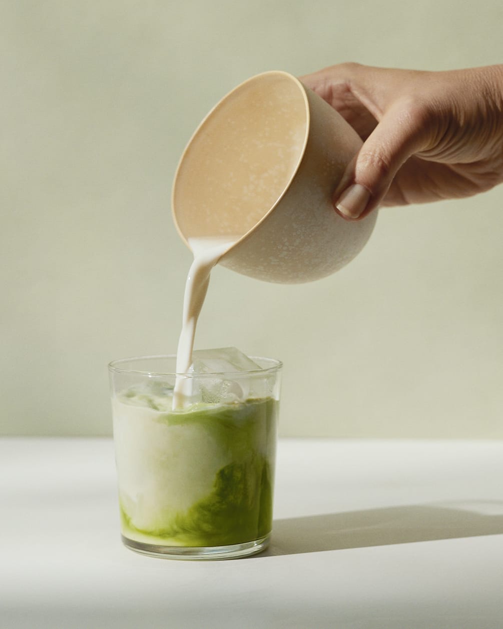 pouring matcha into glass