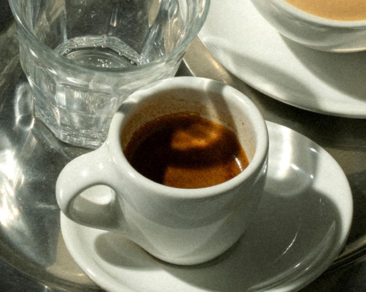 Espresso shot in a demitasse.