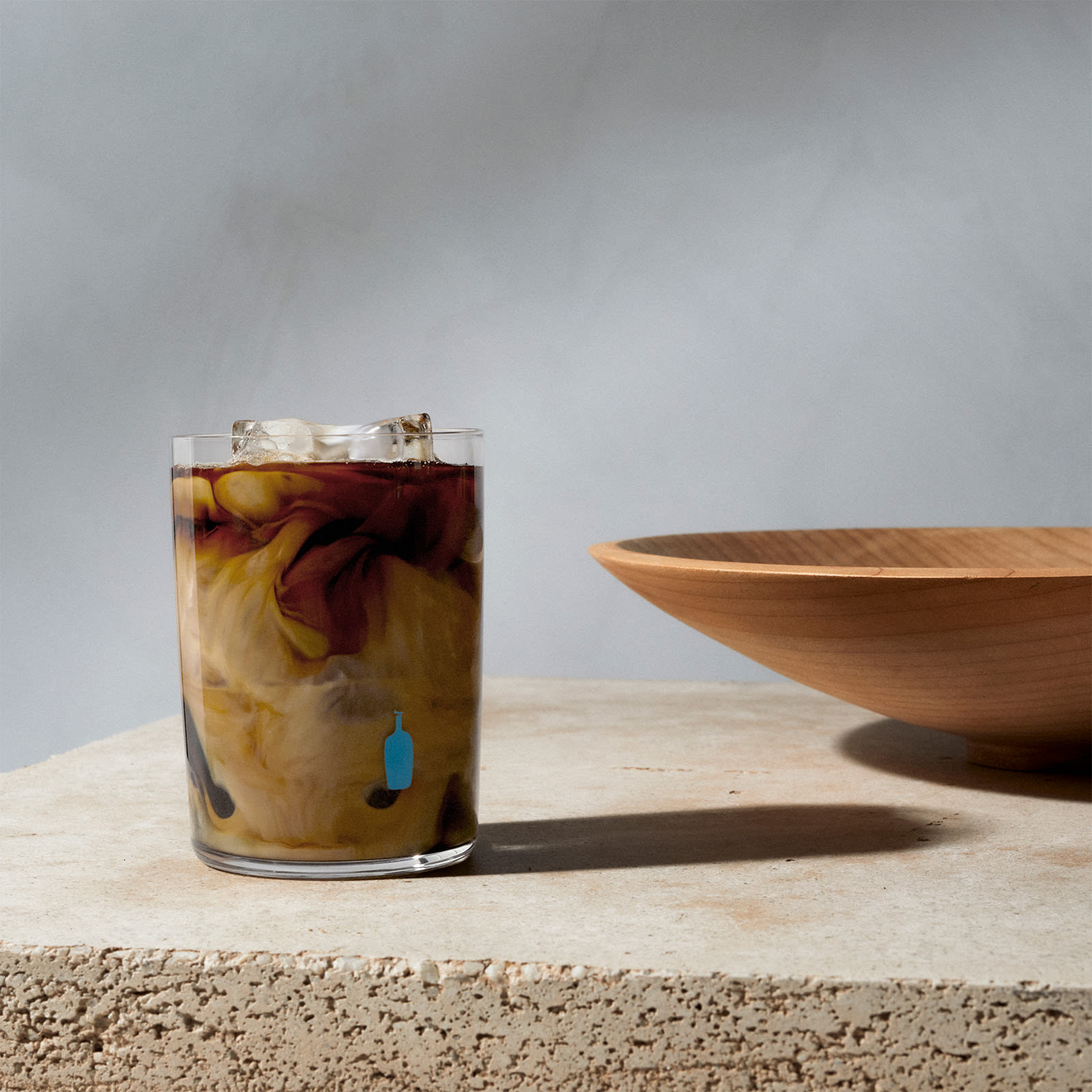 iced coffee in glass with blue bottle coffee logo