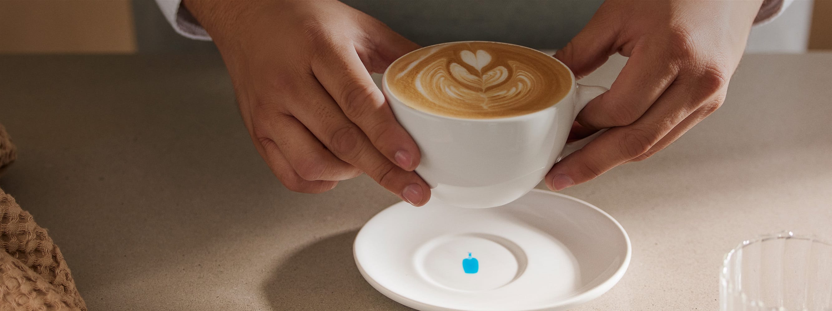 Person holding Blue Bottle Cafe beverage