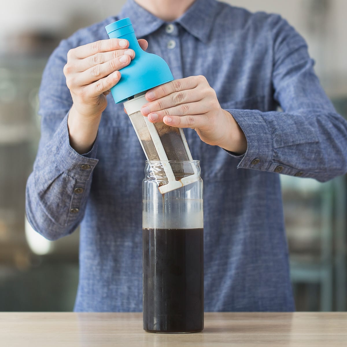 Filter being removed from a cold brew bottle.