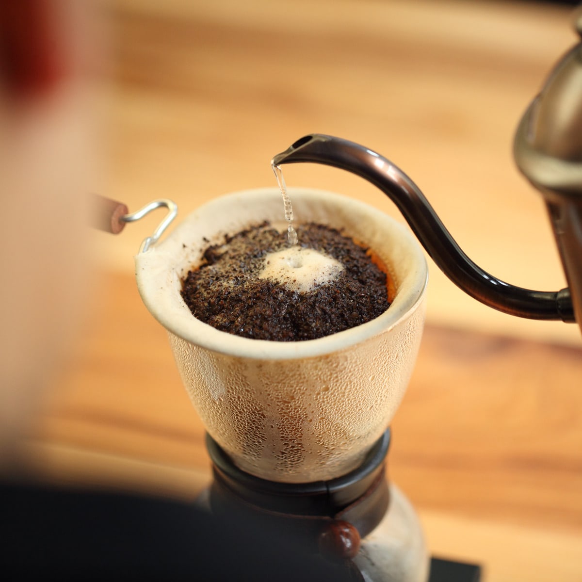 pouring the hot water over the coffee