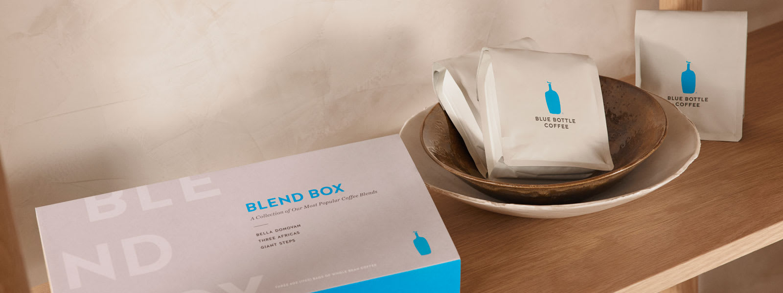 Blend Box and three bags of whole bean coffee on a table.