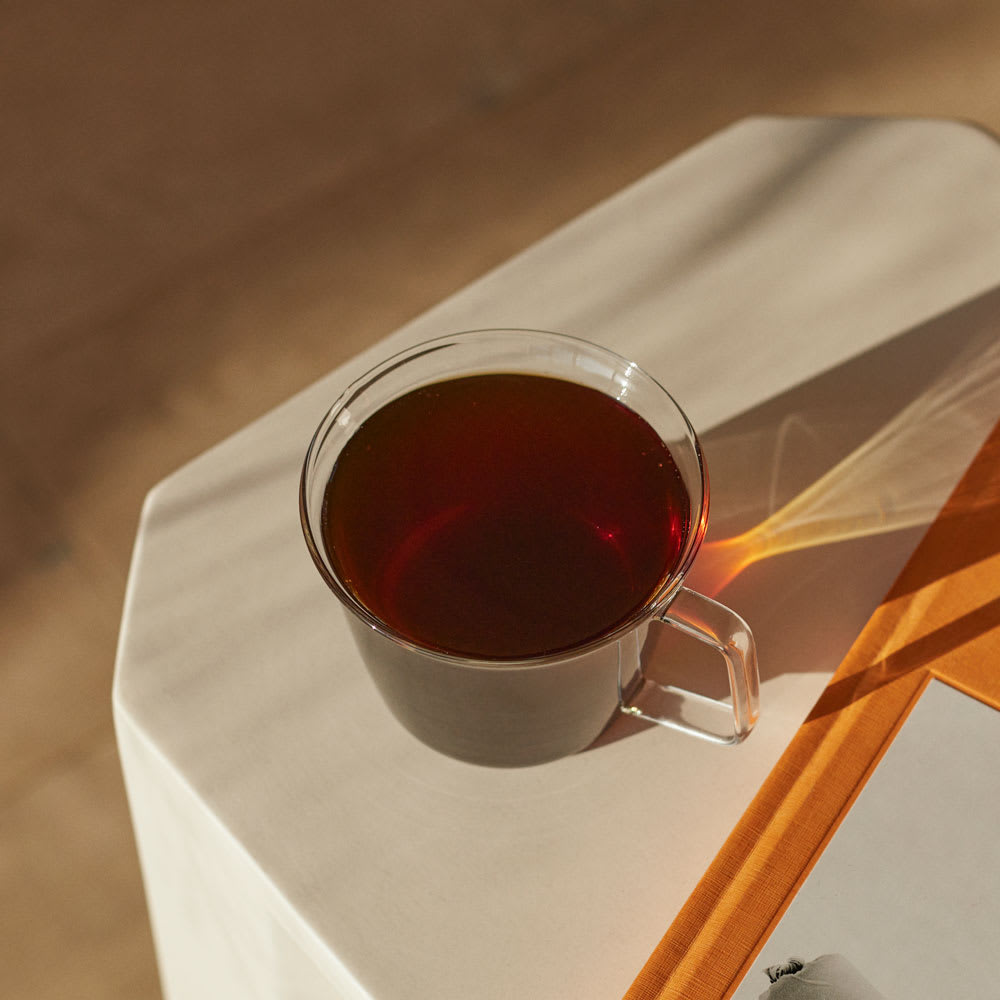 Single Origin Coffee in a glass mug on white table
