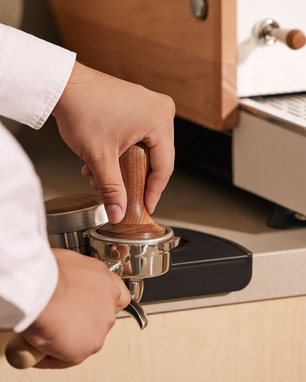Espresso tamper being used to prepare a an espresso shot.