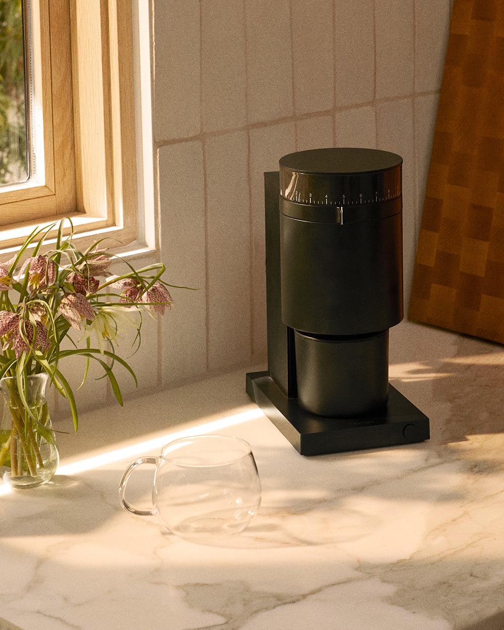 Fellow Opus Grinder on countertop with Kinto Glass Mug