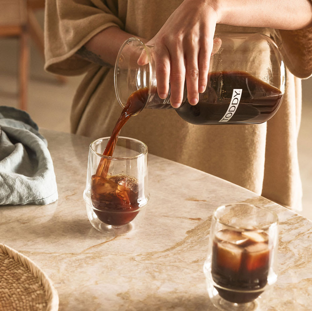 Kinto Kronos Double-walled glasses with cold brew coffee being poured into