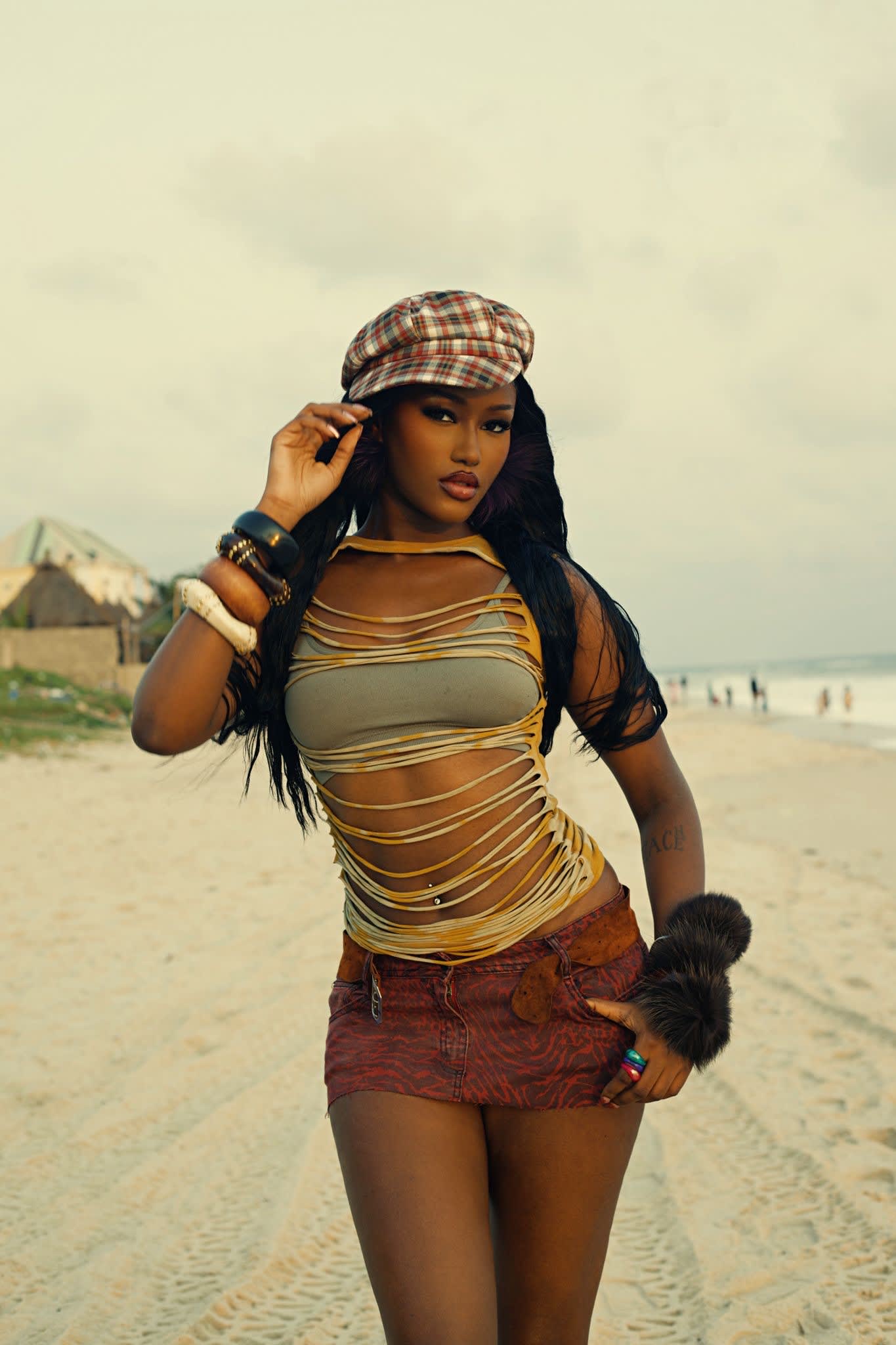 Candice on the beach in a knit top