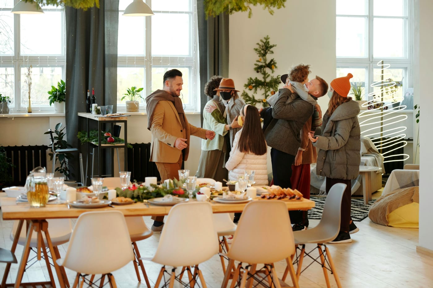 Guests gathered around a festive table, ready for an inclusive Christmas dinner considering special needs such as dietary preferences and allergies.