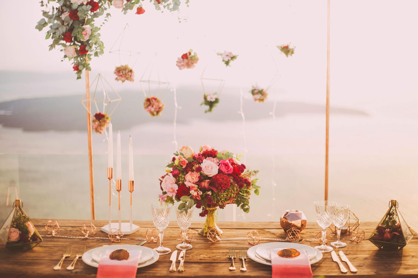 Elegant table setting with floral decorations and candles for a confirmation party, creating an inviting and festive atmosphere.